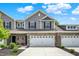 Beautiful townhome with a two-car garage, charming brick accents, and a well-maintained lawn at 6429 Yuma Ct, Whitestown, IN 46075