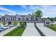 Townhomes with attached garages, a sidewalk, and well-manicured front lawns with young trees and shrubs at 6429 Yuma Ct, Whitestown, IN 46075