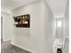 Hallway featuring carpeted floor, decorative shelf with plants, and stairwell at 6429 Yuma Ct, Whitestown, IN 46075