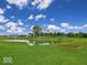 Scenic pond with lush green landscaping, mature trees, and serene water views at 6429 Yuma Ct, Whitestown, IN 46075