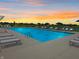 Community pool surrounded by lounge chairs and umbrellas, perfect for a relaxing evening swim at sunset at 6429 Yuma Ct, Whitestown, IN 46075