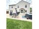 Backyard with patio, dining set, hot tub, and manicured lawn at 6550 Spring Flower Dr, Indianapolis, IN 46237