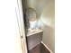 Powder room featuring a stylish vanity with a round mirror, enhancing the home's modern appeal at 6550 Spring Flower Dr, Indianapolis, IN 46237