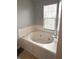 Inviting bathtub with window, creating a tranquil and bright space for relaxation and comfort at 6550 Spring Flower Dr, Indianapolis, IN 46237