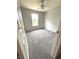 Bright bedroom featuring neutral walls, carpet flooring, a ceiling fan and a window at 6550 Spring Flower Dr, Indianapolis, IN 46237