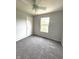 Bedroom with carpet flooring, neutral walls, a ceiling fan, and a window at 6550 Spring Flower Dr, Indianapolis, IN 46237
