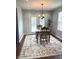 Sunlit dining area with a wooden table set, floral rug, French doors, and recessed lighting at 6550 Spring Flower Dr, Indianapolis, IN 46237