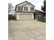 Inviting two-story home with a large driveway, attached garage, and brick detailing at 6550 Spring Flower Dr, Indianapolis, IN 46237