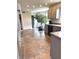 Spacious kitchen featuring gray cabinets, tile flooring, and modern appliances, and a large indoor tree at 6550 Spring Flower Dr, Indianapolis, IN 46237