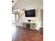 Bright living room featuring hardwood floors, neutral wall paint, and an entertainment center with a fireplace at 6550 Spring Flower Dr, Indianapolis, IN 46237