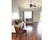 Cozy living room featuring hardwood floors, neutral tones, a ceiling fan, and large windows for ample light at 6550 Spring Flower Dr, Indianapolis, IN 46237