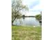 Scenic view of a calm pond, fringed with lush greenery and mature trees creating a peaceful setting at 6550 Spring Flower Dr, Indianapolis, IN 46237