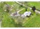 Aerial view of a quaint home on a lush green lot, surrounded by mature trees and a private driveway at 6585 N Waverly Park Rd, Martinsville, IN 46151