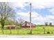 Picturesque red barn set amongst green fields, offering scenic rural charm and potential at 6585 N Waverly Park Rd, Martinsville, IN 46151