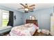 bedroom boasts hardwood floors, a ceiling fan, and a window with a view of the outdoors at 6585 N Waverly Park Rd, Martinsville, IN 46151