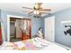 Bedroom boasts hardwood floors, a ceiling fan, and a window with a view of the outdoors at 6585 N Waverly Park Rd, Martinsville, IN 46151