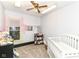 Bright Bedroom featuring a white crib, changing table, and a window with plenty of natural light at 6585 N Waverly Park Rd, Martinsville, IN 46151