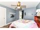 Cozy bedroom features hardwood floors, a ceiling fan, a window, and unique wall decorations at 6585 N Waverly Park Rd, Martinsville, IN 46151
