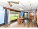 Bright dining room features wood floors, a round table, and lots of natural light from a large window at 6585 N Waverly Park Rd, Martinsville, IN 46151