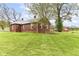 Exterior shot of a brick home with a lush green lawn and mature trees at 6585 N Waverly Park Rd, Martinsville, IN 46151