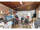 Cluttered garage used for storage, featuring a washing machine, dryer and miscellaneous items at 6585 N Waverly Park Rd, Martinsville, IN 46151