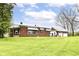 Brick home exterior featuring a grassy lawn and a detached garage at 6585 N Waverly Park Rd, Martinsville, IN 46151