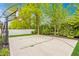Backyard basketball court with green trees, a white fence, and ample space for recreational activities at 6734 W Stonegate Dr, Zionsville, IN 46077