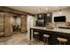 Basement bar area with granite countertops, stylish stools, and stainless appliances at 6734 W Stonegate Dr, Zionsville, IN 46077