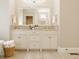 Well-lit bathroom with double vanity, white cabinetry, and a basket of plush white towels at 6734 W Stonegate Dr, Zionsville, IN 46077