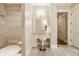 Bright bathroom features a walk-in tiled shower and vanity area with a chair at 6734 W Stonegate Dr, Zionsville, IN 46077