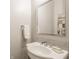 Classic bathroom featuring a white pedestal sink with chrome fixtures and decorative mirror at 6734 W Stonegate Dr, Zionsville, IN 46077
