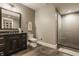 Sleek bathroom featuring modern fixtures, a glass-enclosed shower, and black marble vanity at 6734 W Stonegate Dr, Zionsville, IN 46077