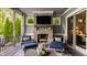 Covered patio with a cozy fireplace and comfortable seating, perfect for outdoor entertaining at 6734 W Stonegate Dr, Zionsville, IN 46077