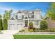 Charming two-story home with a manicured lawn, lovely landscaping, a two-car garage, and a welcoming front entrance at 6734 W Stonegate Dr, Zionsville, IN 46077