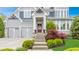 Inviting front entrance with steps leading to a beautifully decorated front door, with professional landscaping at 6734 W Stonegate Dr, Zionsville, IN 46077
