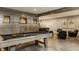 Spacious finished basement with pool table, custom bar, and cozy seating area at 6734 W Stonegate Dr, Zionsville, IN 46077