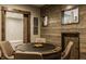 Rustic game room with wood paneled wall, game table, and wood-framed recessed art niches at 6734 W Stonegate Dr, Zionsville, IN 46077