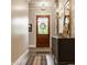 Charming hallway with hardwood floors, decorative mirror and cabinet, and a view to the front door at 6734 W Stonegate Dr, Zionsville, IN 46077