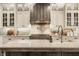 Luxurious kitchen showcasing custom cabinetry, designer backsplash, and a professional-grade stove at 6734 W Stonegate Dr, Zionsville, IN 46077