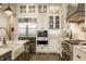Modern kitchen featuring a large island with marble countertops, stainless steel appliances and custom cabinetry at 6734 W Stonegate Dr, Zionsville, IN 46077