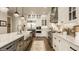 Spacious kitchen with stainless steel appliances, farm sink, large island and access to the dining area at 6734 W Stonegate Dr, Zionsville, IN 46077