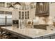 Gourmet kitchen featuring a large island with marble countertops, stainless steel appliances, and modern lighting at 6734 W Stonegate Dr, Zionsville, IN 46077