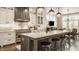 Gourmet kitchen featuring a large island with marble countertops, stainless steel appliances, and ample cabinet space at 6734 W Stonegate Dr, Zionsville, IN 46077