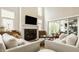 Well-lit living room with a fireplace, shiplap, and comfortable sofas at 6734 W Stonegate Dr, Zionsville, IN 46077