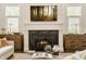 Bright living room featuring a fireplace, shiplap wall, and wooden cabinets at 6734 W Stonegate Dr, Zionsville, IN 46077