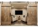 Elegant living room with oversized sliding barn doors and contemporary furnishings at 6734 W Stonegate Dr, Zionsville, IN 46077