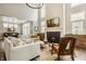 Bright living room with fireplace, shiplap wall, and comfortable seating at 6734 W Stonegate Dr, Zionsville, IN 46077
