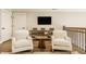 Bright living room features mounted TV, wooden console, and neutral décor at 6734 W Stonegate Dr, Zionsville, IN 46077