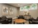 Basement living room with neutral walls, eclectic art, and comfortable leather club chairs at 6734 W Stonegate Dr, Zionsville, IN 46077