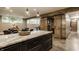 Open concept living space with exposed beam, sliding barn door, stone countertops, and stainless appliances at 6734 W Stonegate Dr, Zionsville, IN 46077
